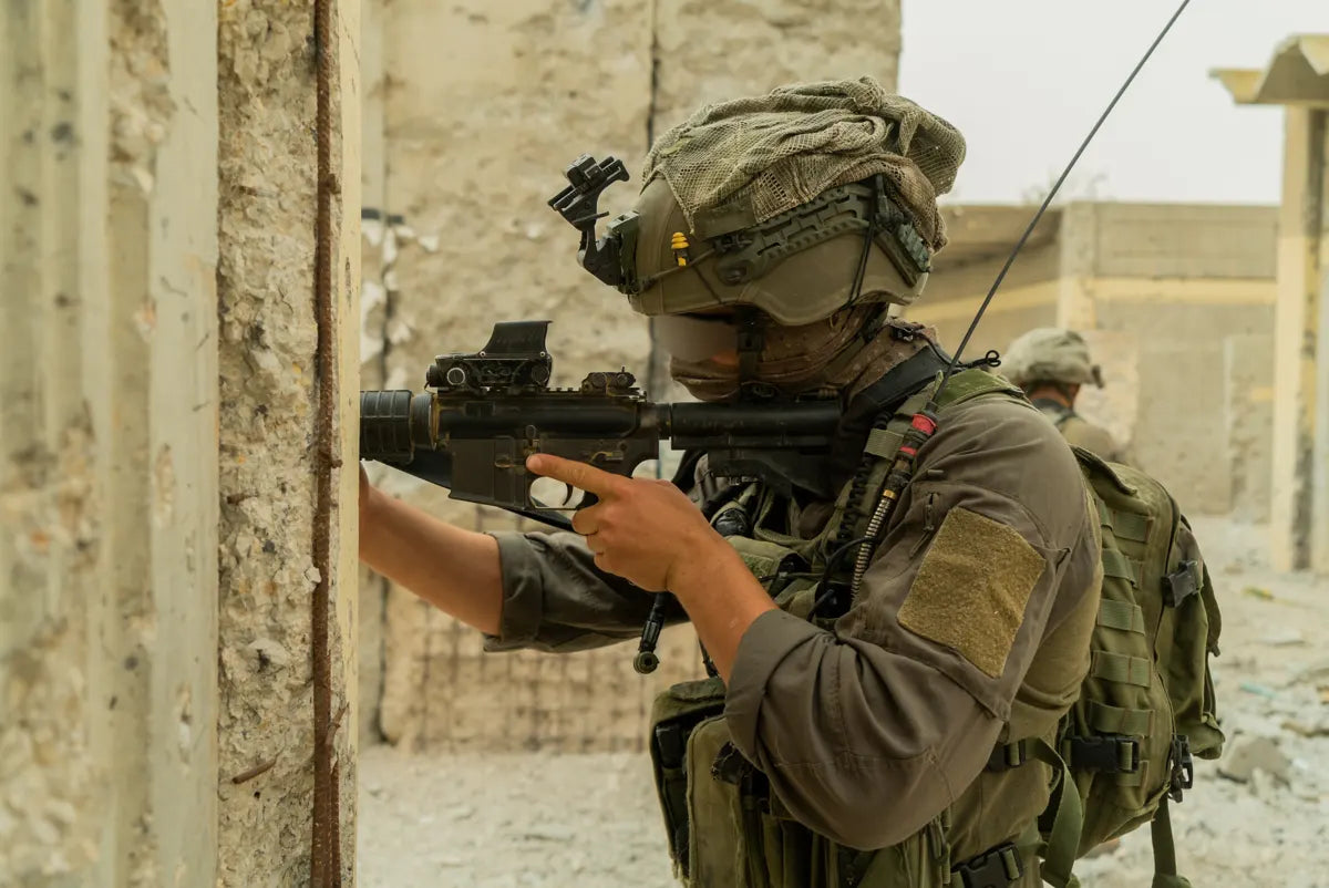 Soldier with optic-equipped rifle in an urban training site